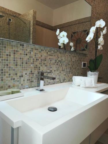 a bathroom with a white sink and a mirror at A CASA DI TATI in Civitanova Marche