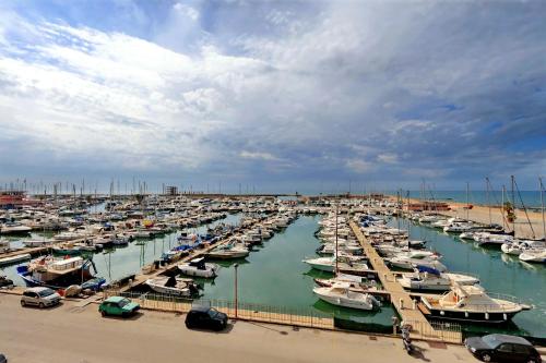a bunch of boats parked in a harbor at Il Borgo Luxury Suites in Nettuno