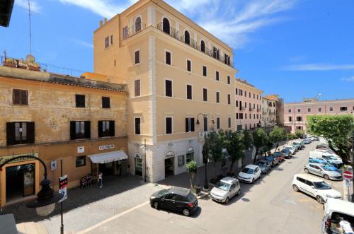 a city street with cars parked in front of buildings at Il Borgo Luxury Suites in Nettuno