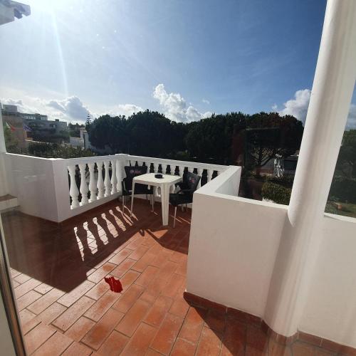 a balcony with a table and a white fence at Agua Marinha ROSA- Hotel in Albufeira