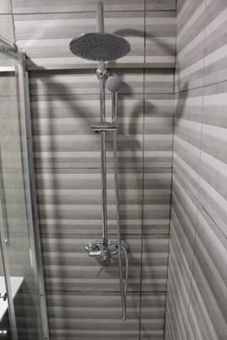 a shadow of a person standing in a shower at Apartment Qiu in Costa da Caparica