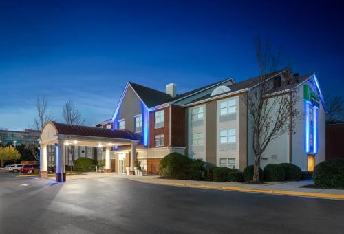 a hotel with a parking lot in front of a building at Holiday Inn Express Alpharetta - Roswell by IHG in Alpharetta