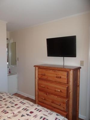 a bedroom with a tv on top of a dresser at Winterplace Ski In Ski Out First Floor D104 in Ghent