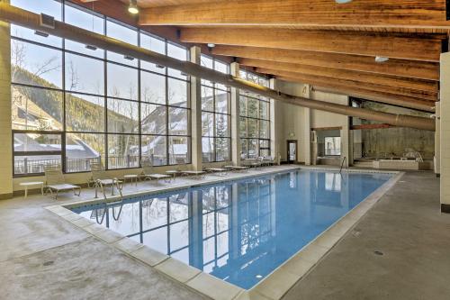 a large indoor swimming pool with a large building with windows at Hot Tub and Ski Shuttle Access Keystone Condo! in Keystone