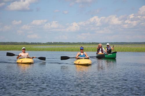 a group of people kayaking on a body of water at Leech Lake Resort Bed & Breakfast in Walker