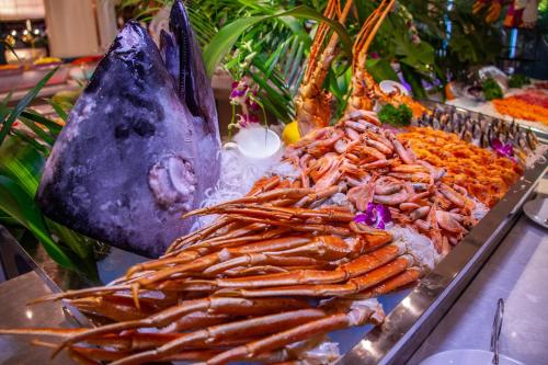 a buffet with many different types of food on display at Wyndham Qingdao l Free Fixed-Time Shuttle Service Between Hotel and Airport & North Railway Station l Outdoor Children's Amusement Park l 1-Hour Play Snooker or Table Tennis in Qingdao