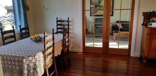 a dining room with a table with a bowl of fruit on it at 113 On Park in Winton