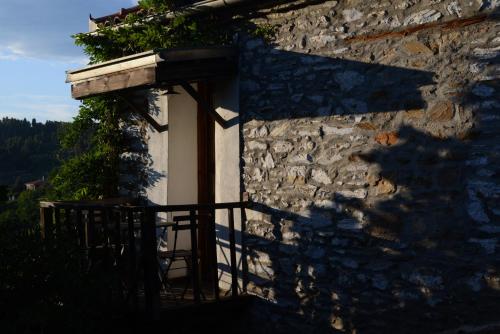 a stone house with a shadow on the side of it at Guesthouse Parthenon in Parthenón