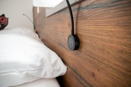 a bedroom with a headboard with a headphone on it at City Hotel Bamberg in Bamberg
