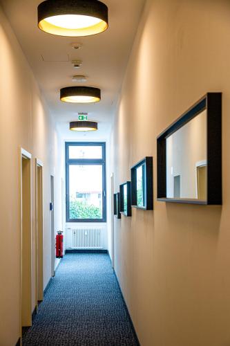 a hallway of an office building with a window at City Hotel Bamberg in Bamberg