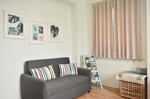 a living room with a couch and a window at 1969 Meters Square Seed B&B in Jian
