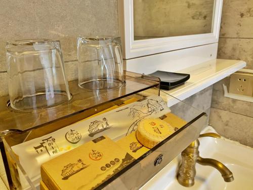 a counter with two glass vases on top of a sink at Mumian inn in Chaozhou