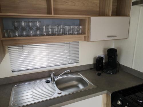 a kitchen counter with a sink and a window at Holiday in Renesse in Renesse