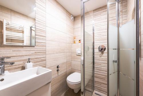 a bathroom with a toilet and a sink and a shower at House Moose't Getaway, Kranjska Gora in Kranjska Gora
