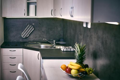 a kitchen with a bowl of fruit on a counter at Holiday apartment High Tatras in Vysoke Tatry - Tatranska Lomnica.
