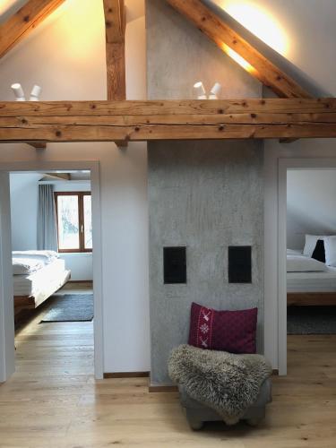 a bedroom with a loft with a bed and a chair at mama käthe - Apartments in Nenzing