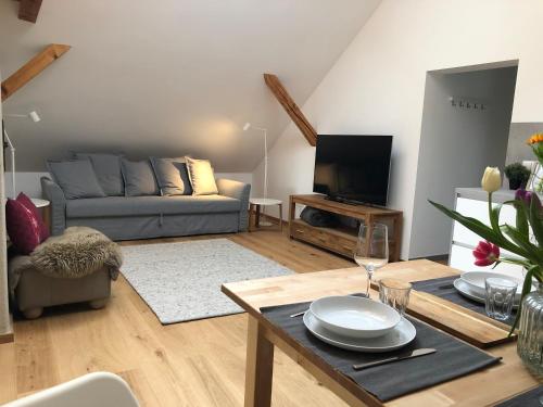 a living room with a couch and a table at mama käthe - Apartments in Nenzing
