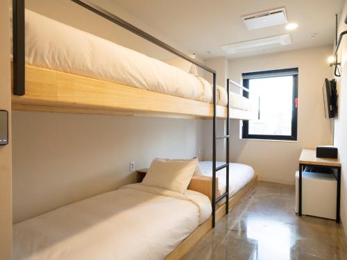 Postel nebo postele na pokoji v ubytování Wegoinn Hostel