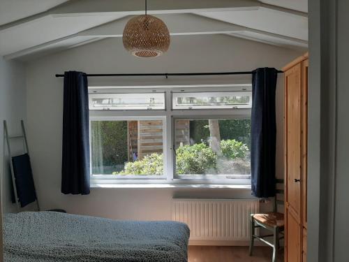 Giường trong phòng chung tại Vakantiehuis La petite Redousse
