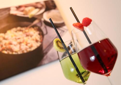 a couple of glasses with fruit on top of a table at City Appartements Villach in Villach