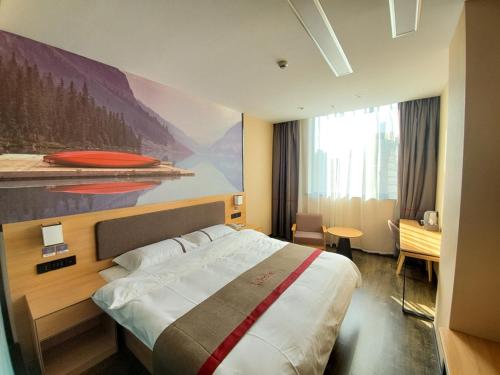 a bedroom with a large bed with a painting on the wall at Thank Inn Chain Hotel Taiyang Yingze District Xiyang City Market City Hall in Taiyuan