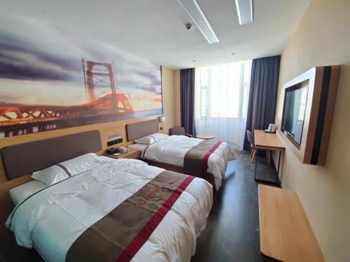 a hotel room with two beds and a painting on the wall at Thank Inn Chain Hotel Taiyang Yingze District Xiyang City Market City Hall in Taiyuan