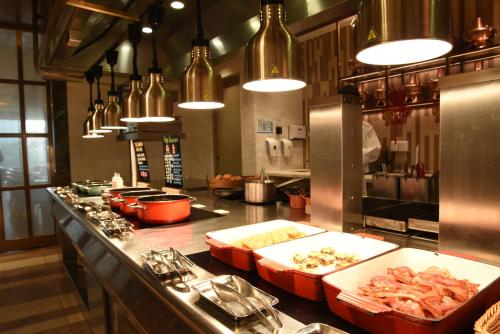 a kitchen with a counter with food on it at The Langham, Hefei in Hefei