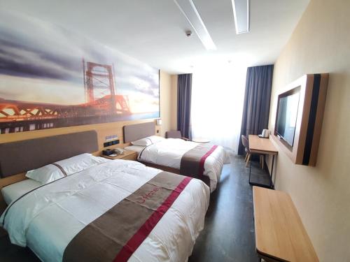 a hotel room with two beds and a television at Thank Inn Chain Hotel Taiyang Yingze District Xiyang City Market City Hall in Taiyuan