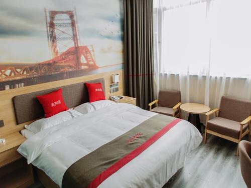 a bedroom with a large bed with red pillows at Thank Inn Chain Hotel Shanxi Taiyuan Yangqu County Plaza in Taiyuan