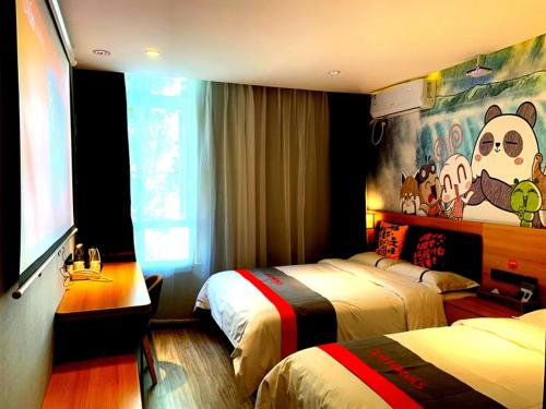 a hotel room with two beds and a monkey mural at JUN Hotels Tianjin Jinnan District University City Pingfan Road in Tianjin