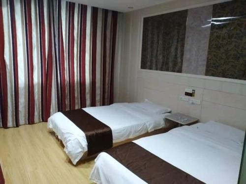 Habitación de hotel con 2 camas y ventana en Thank Inn Chain Hotel Anhui Fuyang Trade City Store, en Fuyang
