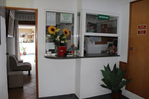 a counter in a room with a vase of flowers at Dom Fernando I in Loulé