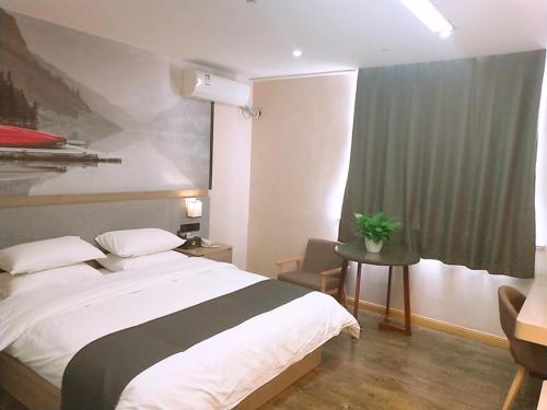 a bedroom with a large white bed and a window at Thank Inn Plus Hotel Jiangsu Suzhou Taicang Liuhe Town Tinghai Road in Taicang