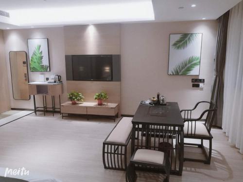 a lobby with a waiting room with chairs and a tv at Thank Inn Chain Hotel Heze Mudan District China Peony Garden in Heze