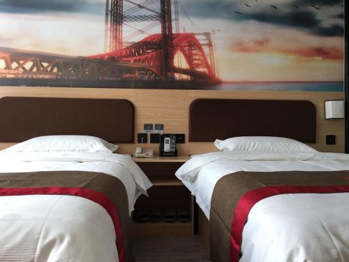 a hotel room with two beds and a painting of a bridge at Thank Inn Chain Hotel Hebei Baoding Jingxiu District Lugang International in Baoding