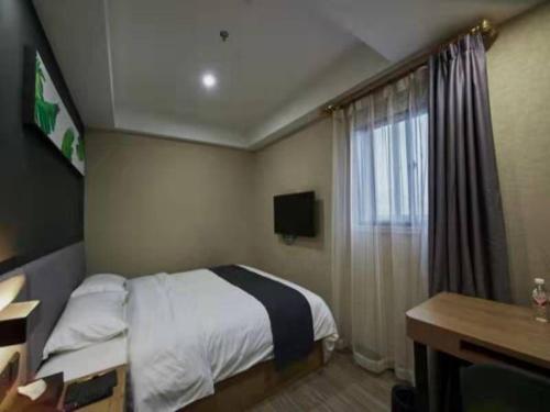 a hotel room with a bed and a window at Up And In Hubei Xianning Tongshan County Building Material Market in Xianning