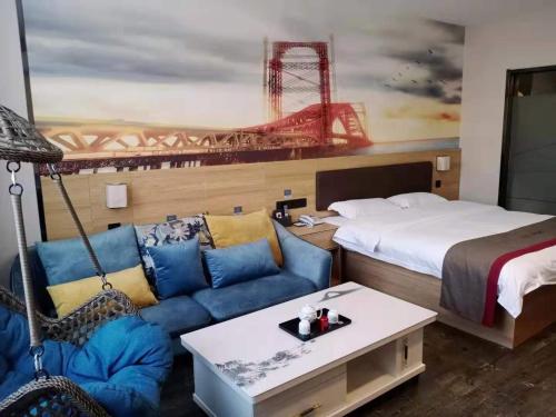 a hotel room with a bed and a couch at Thank Inn Chain Hotel Weifang High-tech Zone Weifang East Expressway Intersection in Weifang