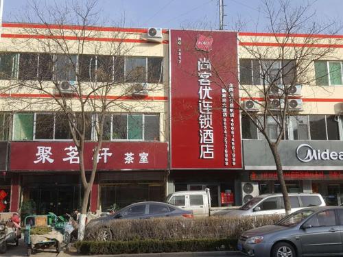 a building with cars parked in front of it at Thank Inn Chain Hotel Shandong Dezhou Jiefang South Avenue Store in Dezhou