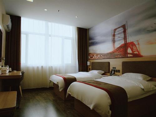 a hotel room with two beds and a large window at Thank Inn Chain Hotel Hebei Baoding Jingxiu District Lugang International in Baoding