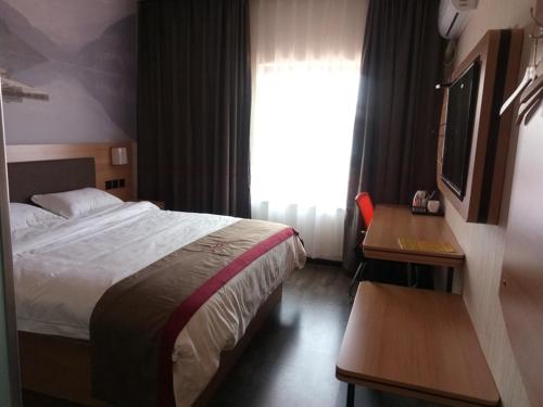 1 dormitorio con cama, escritorio y ventana en Thank Inn Chain Hotel Jiangsu Suzhou Wuzhong Hongzhuang Subway Station en Suzhou
