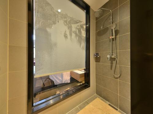 a bathroom with a shower with a large window at Lano Hotel Guangdong Heyuan Dongyuan County Administrative Avenue in Heyuan