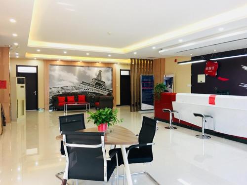 a lobby with a table and chairs and a couch at Thank Inn Chain Hotel Hebei Baoding Jingxiu District Lugang International in Baoding