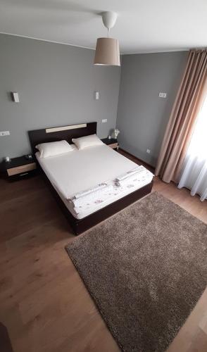 a bedroom with a bed and a rug at Къща за гости Чечев in Sapareva Banya