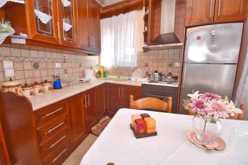a kitchen with a vase of flowers on a table at Traditional House with Amazing View in Chlomós