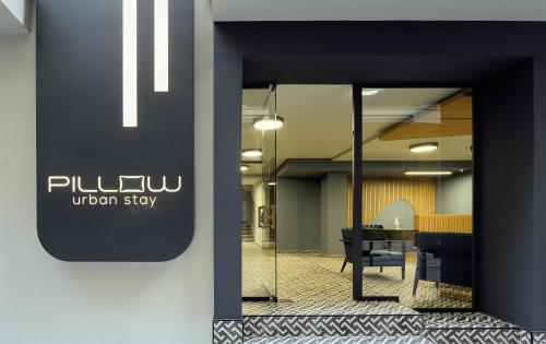 an office lobby with a sliding glass door with a unionstay sign at Pillow urban stay in Thessaloniki