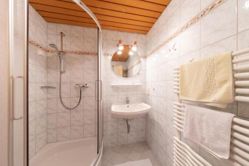a bathroom with a shower and a sink at Alpenhof in Ramsau am Dachstein