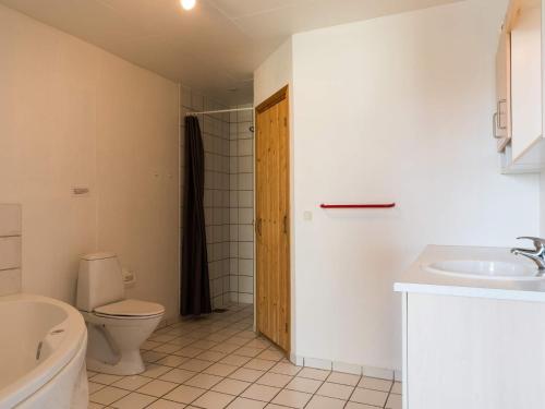 a bathroom with a toilet and a sink at 6 person holiday home in Hvide Sande in Bjerregård