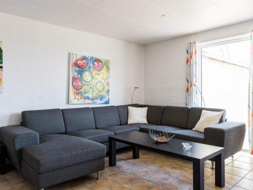 a living room with a couch and a coffee table at 6 person holiday home in Hvide Sande in Bjerregård