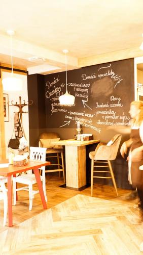 a restaurant with a chalkboard wall with writing on it at Hotel McLimon in Nový Jičín