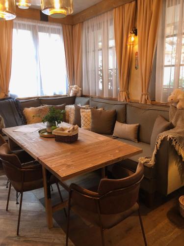 a living room with a wooden table and a couch at Hotel McLimon in Nový Jičín